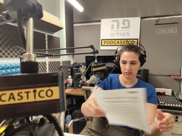 Recording in the Podcastico studio, under the ON AIR sign